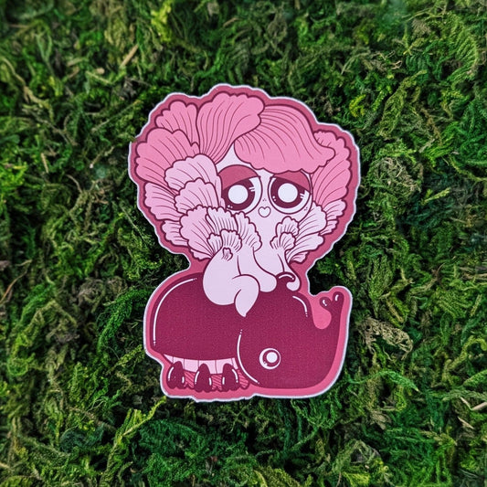 Photograph of a mossy background with a vinyl sticker of a pink oyster Mushkinriding on a pink beetle.