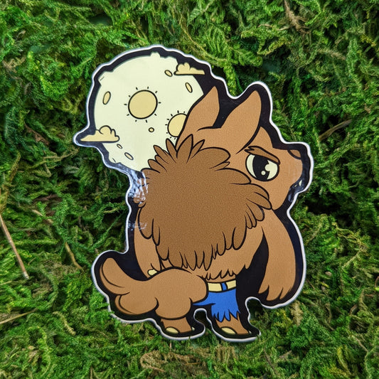 Photograph of a mossy background with a vinyl sticker of a wolf man like creature in ripped jeans with a full moon behind them.