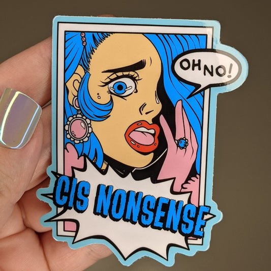 Photograph of a person holding a vinyl sticker of a blue haired person with pink gloves gasping and saying “OH NO!” under them is an action bubble that says “CIS NONSENSE.”