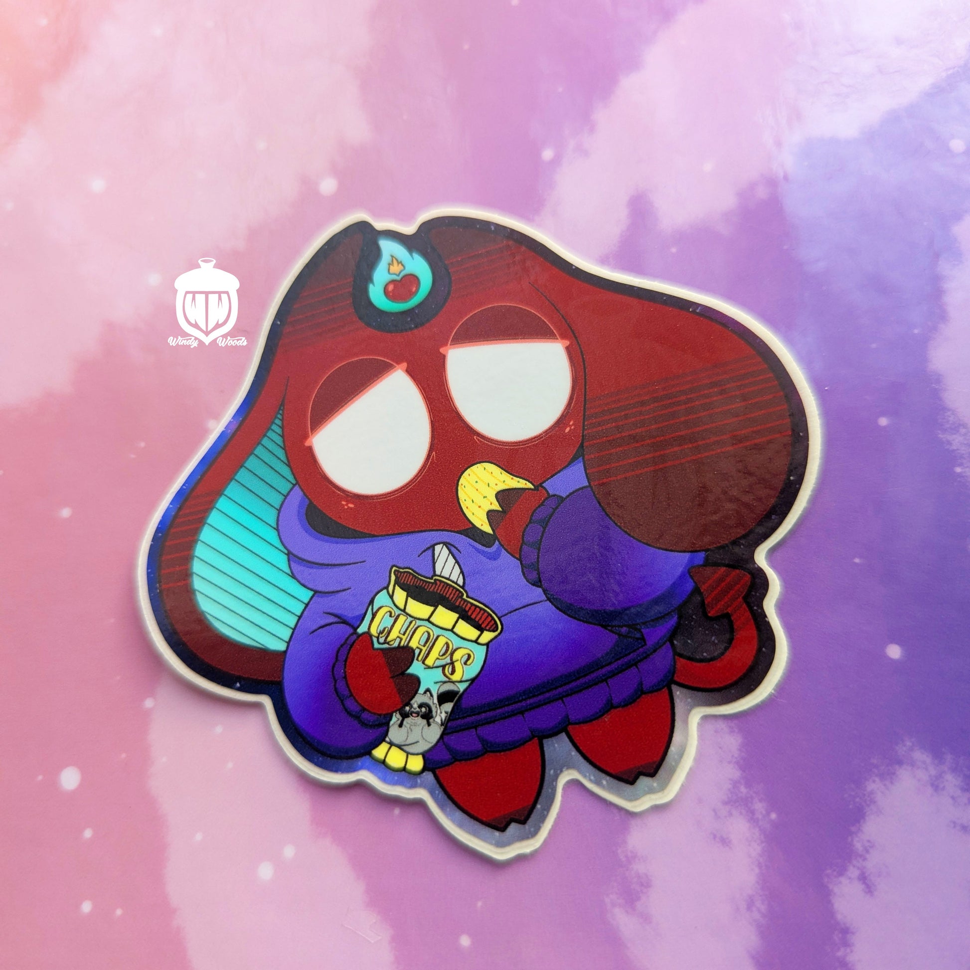 A photograph of a vinyl sticker against a pink and purple background. The sticker features Jack, the lazy demon. The sticker is approx 3 by 3 inches and is made of super durable waterproof vinyl.