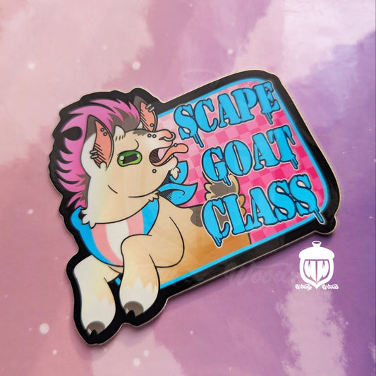 A photograph of a vinyl sticker against a pink and purple background. The sticker features a cute goat with piercings and a pink mohawk. The goat is wearing a bandana with the transgender flag on it. Next to the goat it says, “Scapegoat Class.”