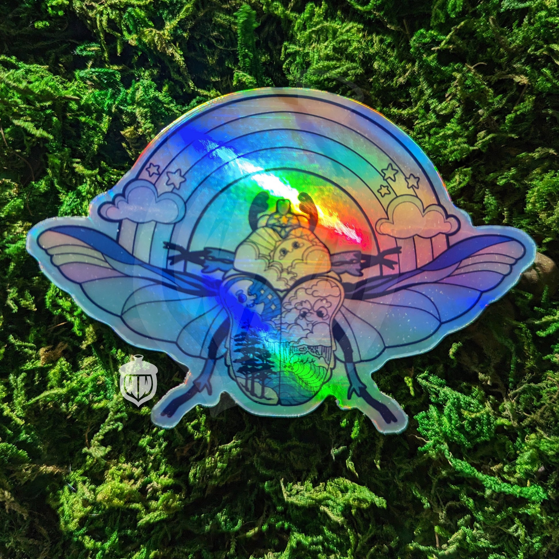 Photograph of a mossy background with a holographic vinyl sticker a beetle with a land and sea theme.